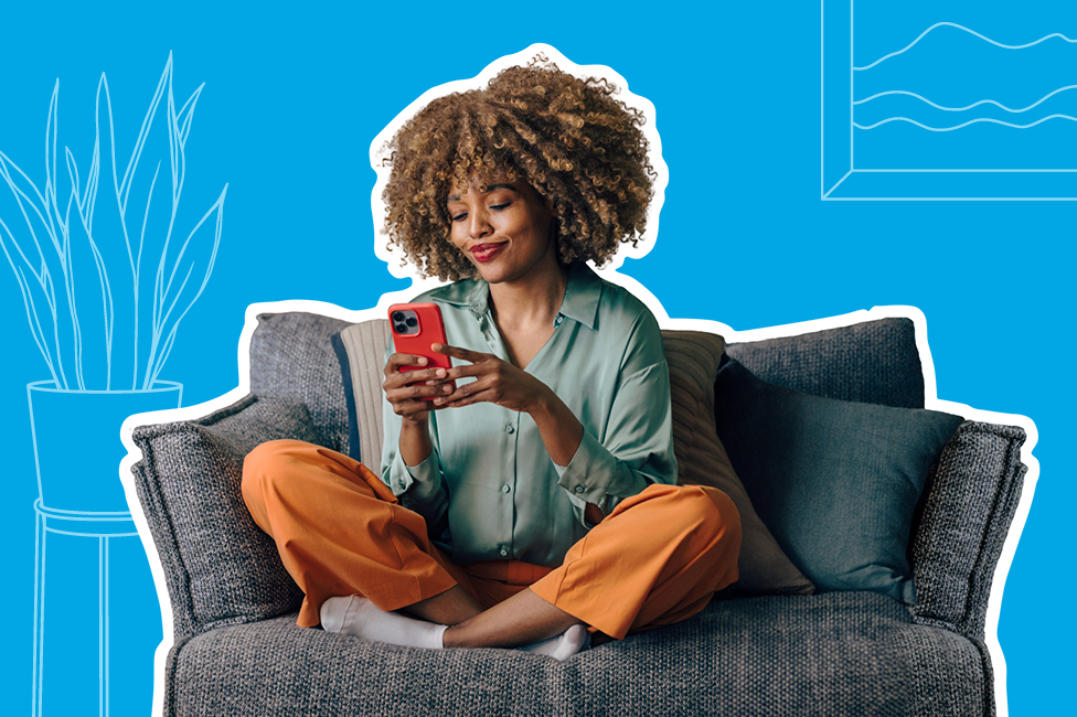 young woman on a comfy couch using her phone